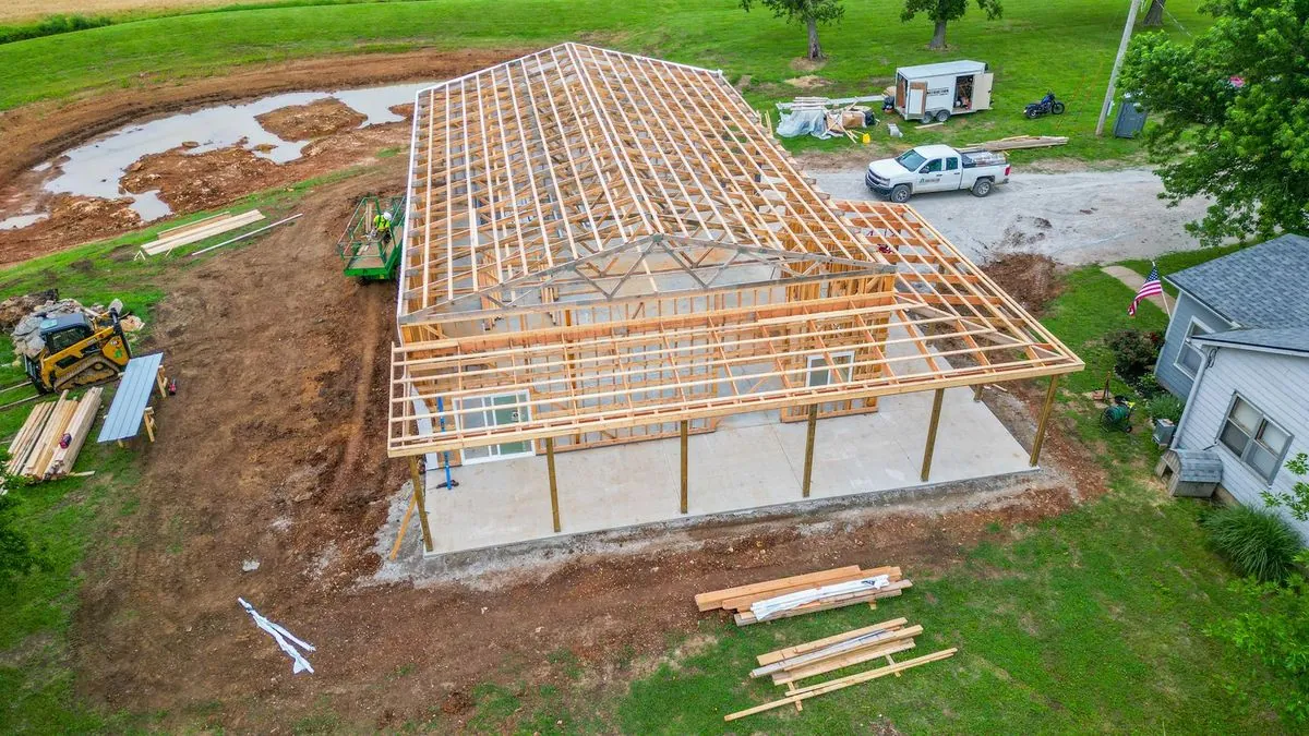Aerial view of wooden roof trusses during barndominium framing